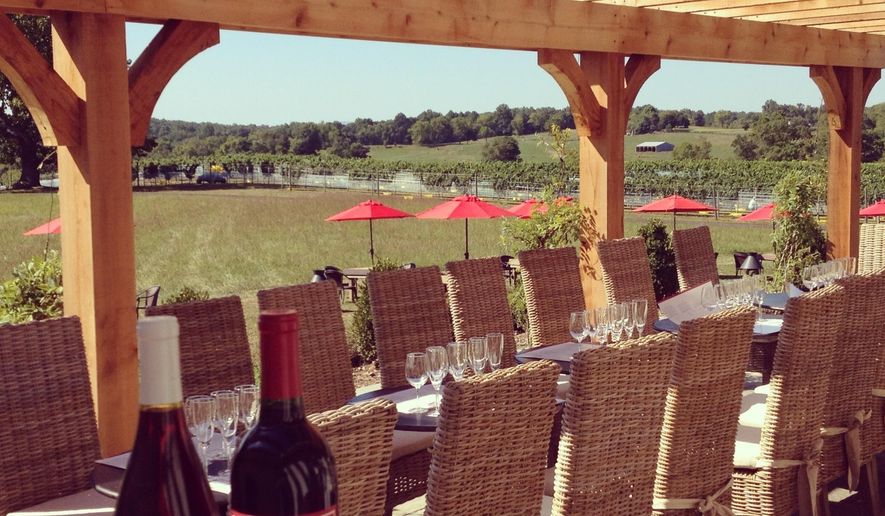 This undated photo provided by Visit Loudoun shows wine bottles on the patio at Greenhill Winery in Middleburg, Va., one of two dozen wineries in Loudoun County. Located about an hour's drive from Washington, D.C., the area calls itself "DC's Wine Country." (Visit Loudoun via AP)