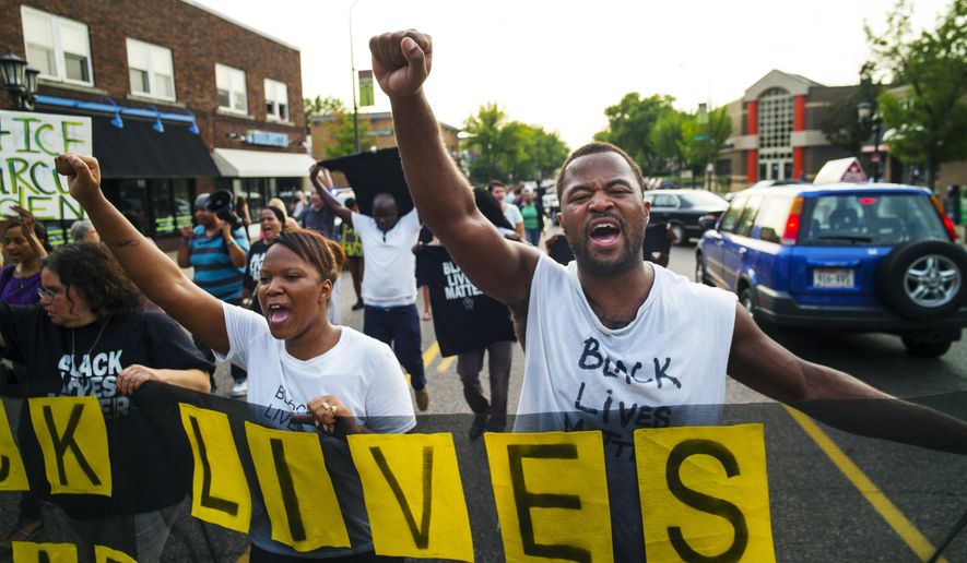 Protest leader, Rashad Turner, far right, leads dozens of protesters in a Black Lives Matter rally in the neighborhood around Governor&#39;s Mansion in St. Paul, Minn. (Richard Tsong-Taatarii /Star Tribune via AP) 