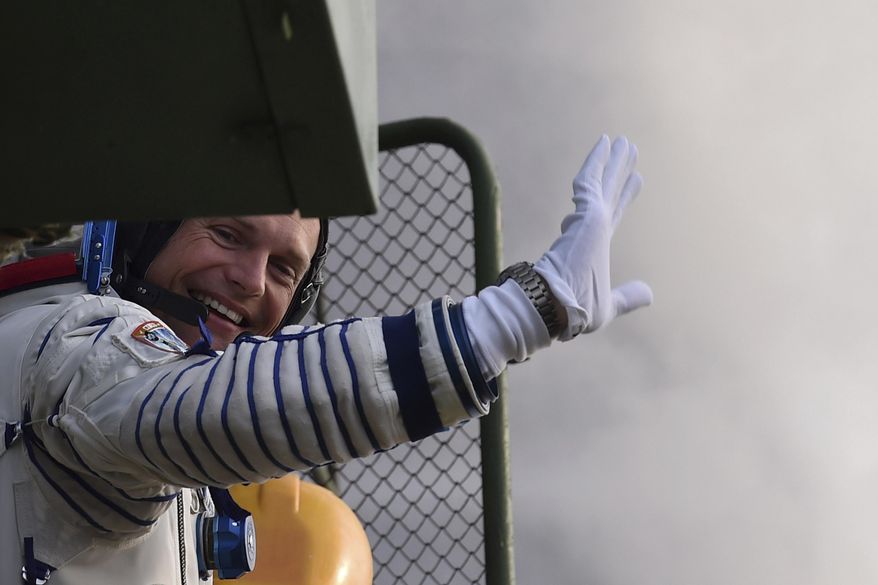 Denmark's astronaut Andreas Mogensen, member of the main crew of the mission to the International Space Station (ISS), gestures near the rocket prior the launch at the Russian leased Baikonur cosmodrome, Kazakhstan, Wednesday, Sept. 2, 2015. (Kirill Kudryavtsev/Pool Photo via AP)