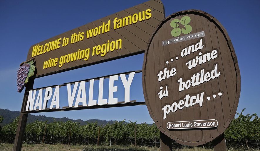 In this photo taken Tuesday, Aug. 25, 2015, a sign welcomes visitors to the Napa Valley in Oakville, Calif. Sunlit hills of lush green vineyards, blue skies, fine red wines, some things about wine country never change. But others do, like where to eat, stay and play. (AP Photo/Eric Risberg)