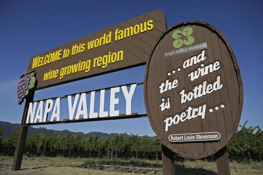 In this photo taken Tuesday, Aug. 25, 2015, a sign welcomes visitors to the Napa Valley in Oakville, Calif. Sunlit hills of lush green vineyards, blue skies, fine red wines, some things about wine country never change. But others do, like where to eat, stay and play. (AP Photo/Eric Risberg)