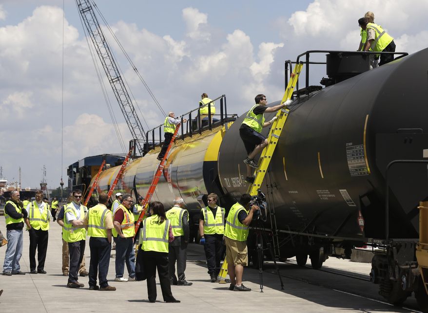 FILE - In this June 5, 2014 file photo, firefighters and other first responders are familiarized with tank cars on the CSX Safety Train in the Port of Albany in Albany, N.Y. Three years after Albany became a major hub for rail shipments of highly flammable crude oil from North Dakota, emergency management officials are still grappling with response plans to deal with a potential disaster. (AP Photo/Mike Groll)