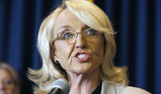 In this Sept. 4, 2013, file photo, Arizona Gov. Jan Brewer speaks in Phoenix. Two online marketing companies are ceasing publication of ads that depict former Arizona Gov. Jan Brewer as an over-the-hill divorcee who needed a &amp;quot;revenge makeover&amp;quot;, Thursday, Sept. 3, 2015. (AP Photo/Ross D. Franklin, File)