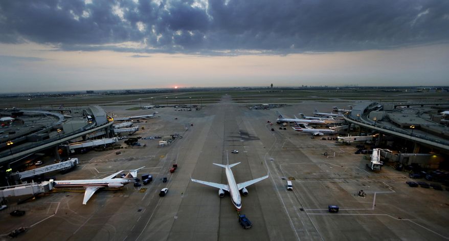 An American Airlines jet is towed into a gate at Dallas/Fort Worth International Airport in Grapevine, Texas, on Aug. 26, 2015. (Associated Press) **FILE**