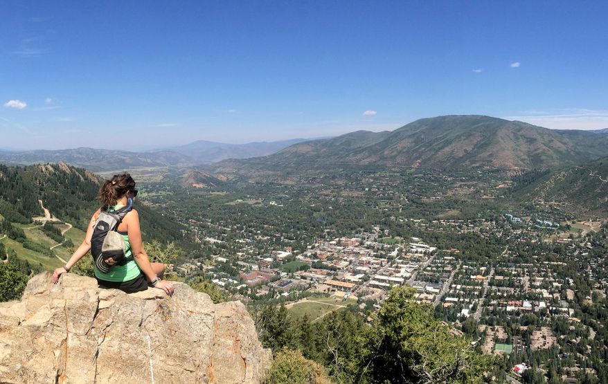 FOR USE IN WEEKEND EDITIONS OF SEPT. 4 - In this photograph from Tuesday, Aug. 18, 2015, an unidentified hiker takes a break on an overlook along Ute Trail above Aspen, Colo. Members of the Roaring Fork Outdoor Volunteers are always toiling to preserve trails in the area. (Jordan Curet/Aspen Daily Times via AP)
