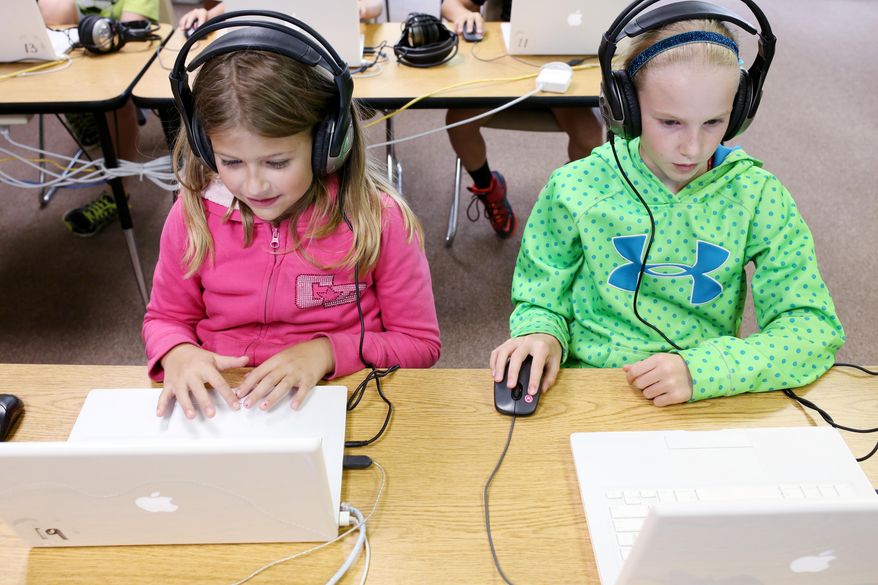 From left, fourth graders Libby Kotik and Allie Vlieger learn aspects of computer coding at Humann Elementary on Aug. 28, 2015 in Lincoln, Neb. Students at Humann Elementary are learning the processes of coding and problem solving through online activities in Jason Rushing's class. (Jenna Vonhofe/The Journal-Star via AP) LOCAL TELEVISION OUT; KOLN-TV OUT; KGIN-TV OUT; KLKN-TV OUT; MANDATORY CREDIT