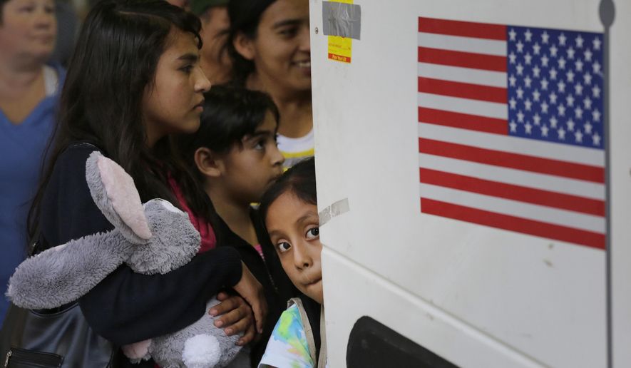 FILE - In this Tuesday, July 7, 2015 file photo immigrants from El Salvador and Guatemala who entered the country illegally board a bus after they were released from a family detention center in San Antonio. Women and children are being released from immigrant detention centers faster on bond, with many mothers assigned ankle-monitoring bracelets in lieu of paying. (AP Photo/Eric Gay, File)