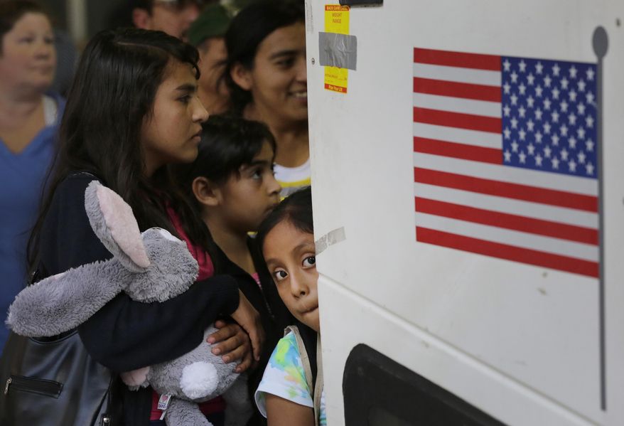 FILE - In this Tuesday, July 7, 2015 file photo immigrants from El Salvador and Guatemala who entered the country illegally board a bus after they were released from a family detention center in San Antonio. Women and children are being released from immigrant detention centers faster on bond, with many mothers assigned ankle-monitoring bracelets in lieu of paying. (AP Photo/Eric Gay, File)