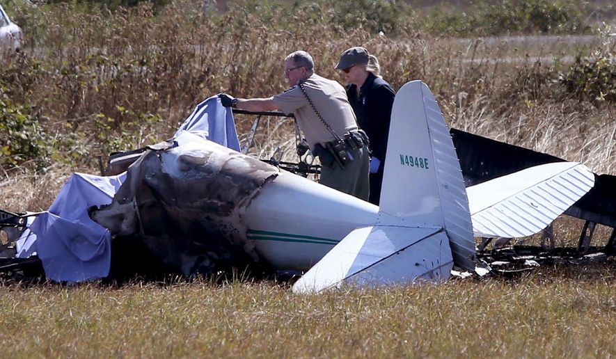 Officials investigate the site of small plane crash on the northwest end of the Creswell Airport in Creswell, Ore., Monday, Sept. 7, 2015. The Lane County Sheriff&#x27;s Office, which was investigating, has not released the names of the people who were aboard. (Chris Pietsch/The Register-Guard via AP) MANDATORY CREDIT