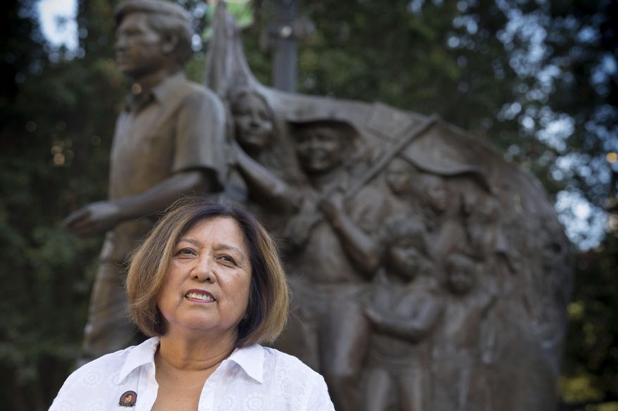 Lorraine Agtang, of Sacramento, stands in front of the Cesar Chavez monument at Chavez Plaza that includes her likeness on Thursday, Sept. 3, 2015. Agtang, one of the few living Filipino grape strikers who launched the most famous strike in modern American history, is going back to where it all began in Delano this weekend. She represents the partnership between Filipino and Mexican farm workers who had the courage to launch the first major farm worker's strike that drew international support and led to major changes in the fields. Agtang, whose dad was a Filipino farm worker and his mom a Mexican farm laborer, went on to become such an important voice in the movement she's enshrined on the Cesar Chavez memorial statue in Cesar Chavez Park. (Hector Amezcua/The Sacramento Bee via AP) MAGS OUT; TV OUT (KCRA3, KXTV10, KOVR13, KUVS19, KMAZ31, KTXL40) MANDATORY CREDIT