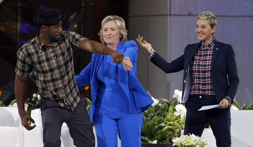 Democratic presidential candidate Hillary Rodham Clinton, center, practices her dance moves with DJ Stephen &quot;Witch&quot; Boss and Ellen DeGeneres during a break in the taping of The Ellen DeGeneres Show, Tuesday, Sept. 8, 2015, at Rockefeller Center in New York. (AP Photo/Mary Altaffer)