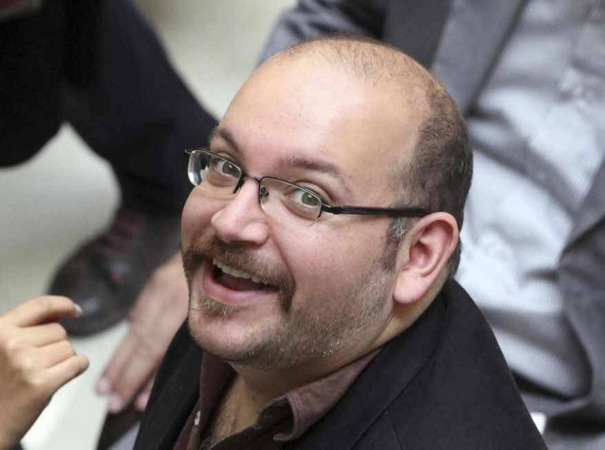 Jason Rezaian, an Iranian-American correspondent for The Washington Post, smiles as he attends a presidential campaign of President Hassan Rouhani in Tehran, Iran, in this April 11, 2013, file photo. (AP Photo/Vahid Salemi, File) 
