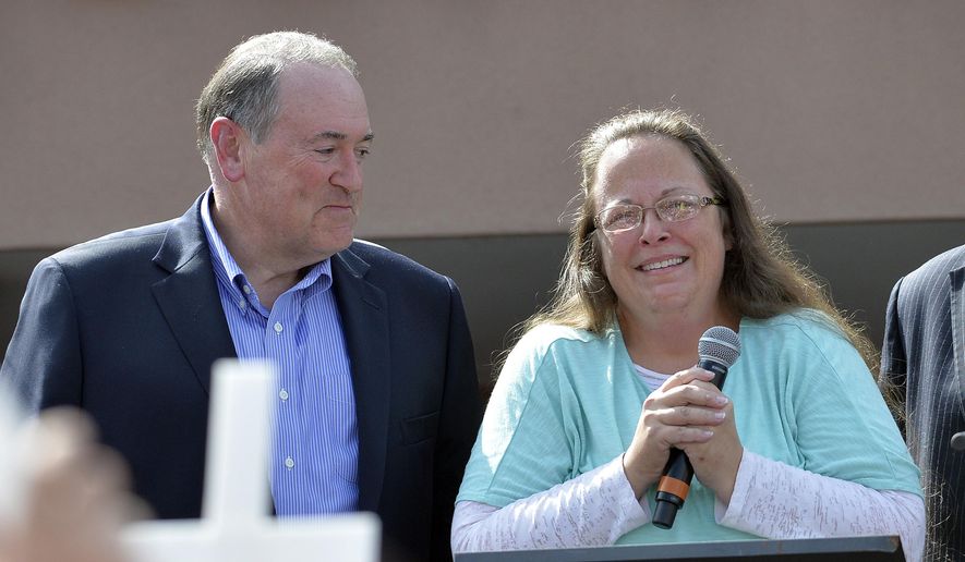Rowan County Clerk Kim Davis, with Republican presidential candidate Mike Huckabee, left, at her side, speaks after being released from the Carter County Detention Center, Tuesday, Sept. 8, 2015, in Grayson, Ky. Davis, the Kentucky county clerk who was jailed for refusing to issue marriage licenses to gay couples, was released Tuesday after five days behind bars. (AP Photo/Timothy D. Easley)