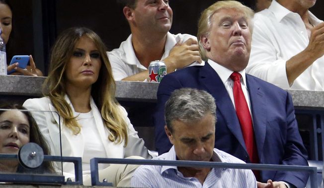 Republican presidential candidate Donald Trump, right, and his wife Melania, left, wait to watch a quarterfinal match between Serena Williams and Venus Williams at the U.S. Open tennis tournament, Tuesday, Sept. 8, 2015, in New York. (AP Photo/Julio Cortez)