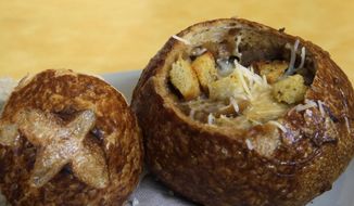 This June 9, 2015, file photo, shows a Bistro French Onion Soup Bread Bowl at a Panera bread restaurant in New York. The city Board of Health voted unanimously Wednesday, Sept. 9 to require chain eateries to put salt-shaker symbols on menus to denote dishes with more than the recommended daily limit of 2,300 milligrams of sodium. (AP Photo/Mary Altaffer, File)