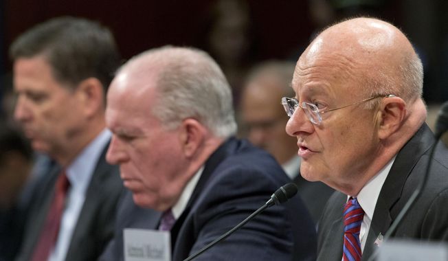 Director of National Intelligence James Clapper, right, with CIA Director John Brennan, center, and FBI Director James Comey, left, testifies on Capitol Hill in Washington, Thursday, Sept. 10, 2015, before the House Intelligence Committee hearing on cyberthreats. (AP Photo/Pablo Martinez Monsivais)