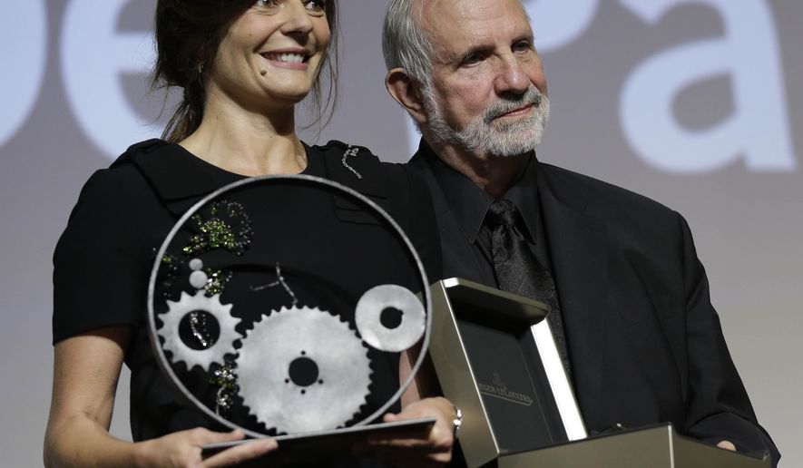 Director Brian De Palma, right, poses with actress Chiara Mastroianni with the Glory To The Filmmaker Award 2015 during the award ceremony at the 72nd edition of the Venice Film Festival in Venice, Italy, Wednesday, Sept. 9, 2015. The 72nd edition of the festival runs until Sept. 12. (AP Photo/Andrew Medichini)