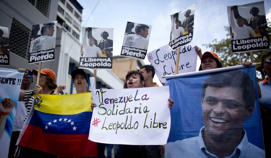 People chant slogans in support of jailed opposition leader Leopoldo Lopez, outside the courthouse in Caracas, Venezuela, Thursday, Sept. 10, 2015. Members of Lopez's party arrived early in the morning to protest and pray, as they have dozens of times since Lopez's imprisonment 19 months ago. Lopez is accused of fomenting violence during a 2014 protest movement, and a verdict could come soon. (AP Photo/Ariana Cubillos) ** FILE **