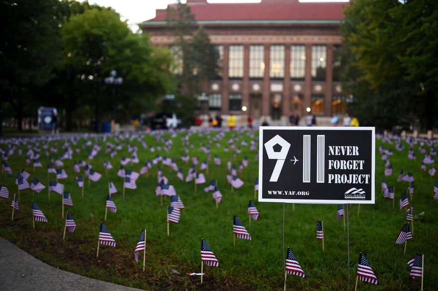 2,977 small American flags were placed in the ground as part of the 9/11 Never Forget Project memorial at the Diag at the University of Michigan in Ann Arbor, Mich., on Friday, Sept. 11, 2015. (Melanie Maxwell /The Ann Arbor News via AP) LOCAL TELEVISION OUT; LOCAL INTERNET OUT; MANDATORY CREDIT