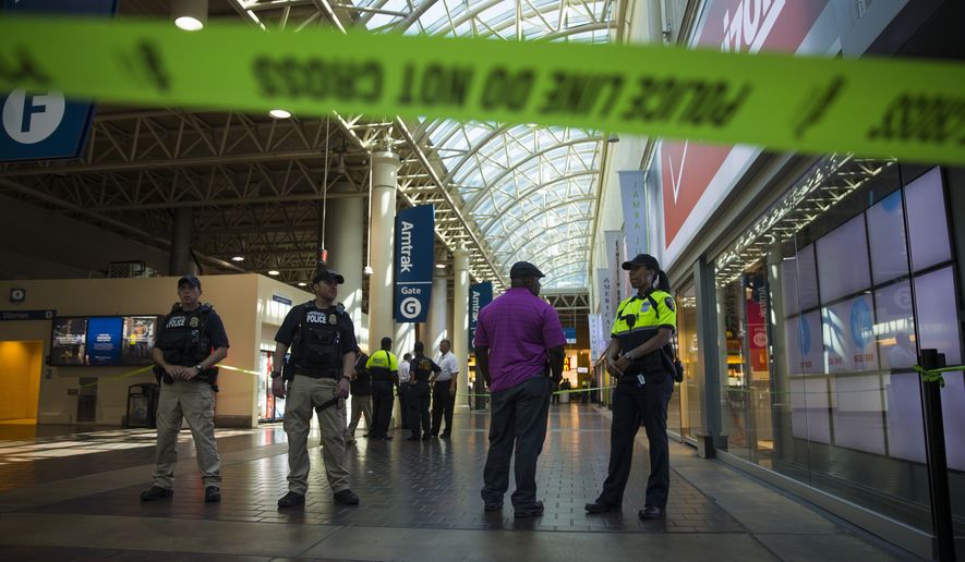 Police and emergency responders stand outside a McDonald's located inside Union Station in Washington, Friday, Sept. 11, 2015, after a security guard shot a suspect who attacked a worker with a knife at the restaurant. (AP Photo/Evan Vucci)