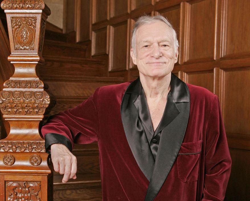 In this April 7, 2006 photo, Playboy founder Hugh Hefner poses at the Playboy Mansion in the Holmby Hills area of Los Angeles. The new book "Playboy Swings" releasing on Sept. 14, 2015, details Hefner's contribution to popularizing jazz and his stand against racial segregation in entertainment. (AP Photo/Kevork Djansezian, File)