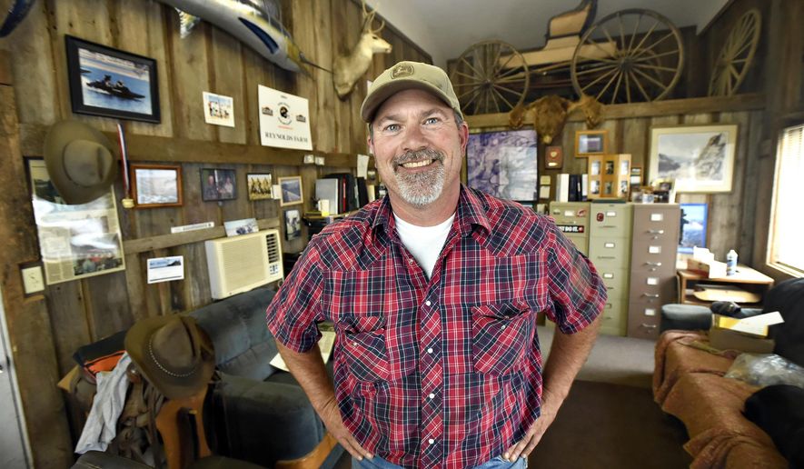 ADVANCE FOR USE SATURDAY, SEPT. 12 - In this photo taken, Aug. 15, 2015, Kenny Reynolds, who still farms the land his great-great-grandfather homesteaded just north of Corvallis, Ore., poses for a photo at his office at Reynolds Farms.,The office is filled with family memorabilia. (Andy Cripe/The Corvallis Gazette-Times via AP) MANDATORY CREDIT