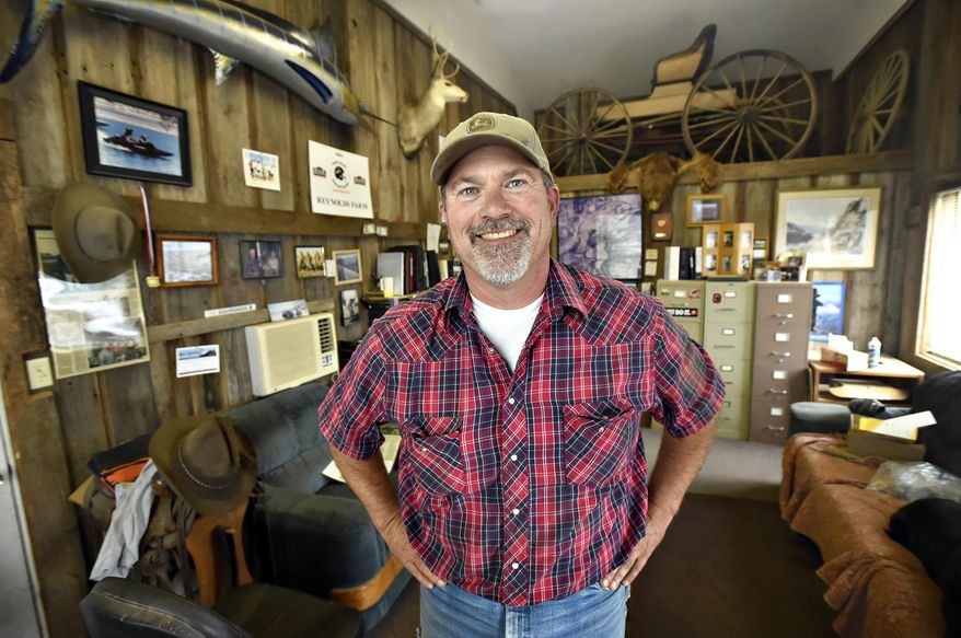 ADVANCE FOR USE SATURDAY, SEPT. 12 - In this photo taken, Aug. 15, 2015, Kenny Reynolds, who still farms the land his great-great-grandfather homesteaded just north of Corvallis, Ore., poses for a photo at his office at Reynolds Farms.,The office is filled with family memorabilia. (Andy Cripe/The Corvallis Gazette-Times via AP) MANDATORY CREDIT