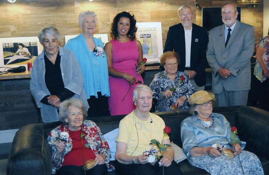 ADVANCE FOR SUNDAY SEPT. 13 - In this Sept 8, 2015 photo, front row from left, Ada England, Ruth Staples, Crena Anderson, back row from left, Anne Montague, Anna Hess, Sammi Brown, Ethel Bovey, Hugo Kessing, and John Christensen at the Eastern Panhandle Cenral Labor Council's "An Evening with Rosie: the Rosie the Riveter Movement at the HUB in Martinsburg W. Va. Although the women haven't sat down to a typewriter or welded aircraft pieces together in several decades, five regional women's contributions during World War II were recognized, when they earned title of "Rosie." (Ron Agnir/The Journal via AP) MANDATORY CREDIT