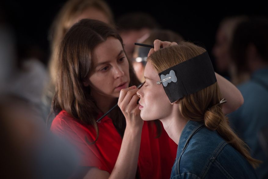 A model is prepared backstage prior to the Prabal Gurung Spring 2016 show at Fashion Week on Sunday, Sept. 13, 2015, in New York. (AP Photo/Bryan R. Smith)