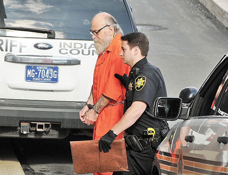 FILE - In this Aug. 13, 2015 file photo, Lewis Fogle, left, is escorted to the back door of the Indiana County Courthouse by Deputy Dave Angelo in Indiana, Pa. The Indiana County district attorney is scheduled to announce on Monday, Sept. 14, 2015 whether he'll retry Fogle for second-degree murder in the rape and shooting death of a 15-year-old girl in 1976. Fogle, who spent 34 years in prison for the crime, had a judge vacate his murder conviction, citing new DNA evidence. (Tom Peel/The Indiana Gazette via AP, File)