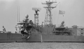 The USS Stark, its flag at half mast, limps toward Bahrain Tuesday, May 19, 1987, with a gaping and jagged hole in the hull below her bridge. Thirty-seven sailers were killed when a French-made Exocet missile exploded on the Stark after being fired at by an Iraq jet fighter Sunday night. (AP Photo/Zouhair Saade)