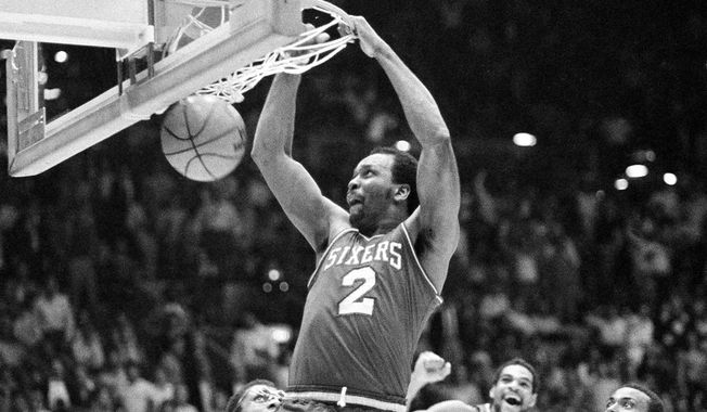 Philadelphia 76ers&#x27; Moses Malone slams home two of his 24 points in a playoff game against the Lakers, in Los Angeles, Calif., on June 1, 1983. The Sixers went on to sweep the Lakers four games straight to win the NBA championship. (AP Photo)