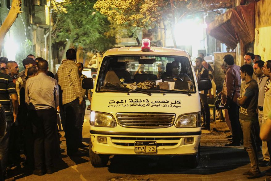 A funeral vehicle carrying an Egyptian victim of Sunday's incident in which Egyptian forces mistakenly opened fire on tourists in the western desert, arrives at a morgue in Cairo, Egypt, Monday, Sept. 14, 2015. Egyptian forces hunting militants in the country's western desert mistakenly opened fire on Mexican tourists on safari, killing 12 people and dealing a further blow to the government's efforts to project an image of stability as it fights an increasingly powerful insurgency, officials said Monday. (AP Photo/Mohamed Elraai)