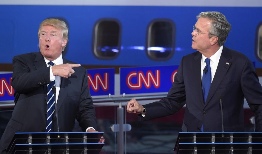 Republican presidential candidates, former Florida Gov. Jeb Bush, right, and Donald Trump both speak during the CNN Republican presidential debate at the Ronald Reagan Presidential Library and Museum on Wednesday, Sept. 16, 2015, in Simi Valley, Calif. (AP Photo/Mark J. Terrill)