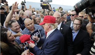 Republican presidential candidate Donald Trump, center, greets supporter after speaking at a campaign event aboard the USS Iowa battleship in Los Angeles Tuesday, Sept. 15, 2015. (AP Photo/Kevork Djansezian)