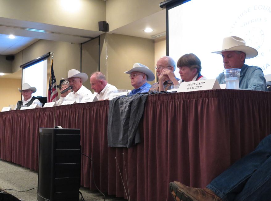 Rancher Ed Ashurst, third from left, criticizes the federal government over its enforcement of border safety during a meeting for border sheriffs in Sierra Vista, Ariz., on Wednesday, Sept. 16, 2015. Ashurts owns a ranch 20 miles north of the border with Mexico, east of Douglas, Ariz. Others are unidentified. (AP Photo/Astrid Galvan)