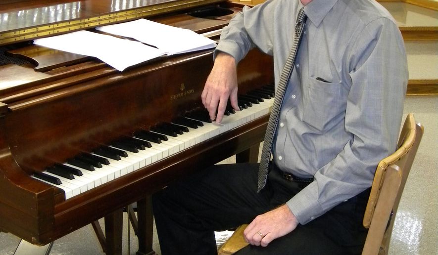 Robert Hobby, director of music at Trinity English Lutheran Church in Fort Wayne, Ind., poses for a photo, Sept. 11, 2015. Hobby wrote two pieces of music that are scheduled for use during worship services Pope Francis will lead Sept. 24-25 while in New York. (Kevin Kilbane/The News-Sentinel via AP) JOURNAL GAZETTE OUT MANDATORY CREDIT NO SALES MAGS OUT