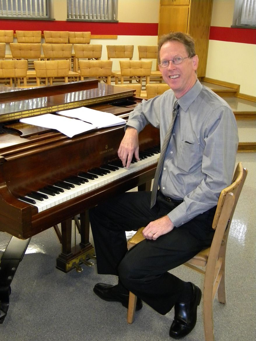 Robert Hobby, director of music at Trinity English Lutheran Church in Fort Wayne, Ind., poses for a photo, Sept. 11, 2015. Hobby wrote two pieces of music that are scheduled for use during worship services Pope Francis will lead Sept. 24-25 while in New York. (Kevin Kilbane/The News-Sentinel via AP) JOURNAL GAZETTE OUT MANDATORY CREDIT NO SALES MAGS OUT