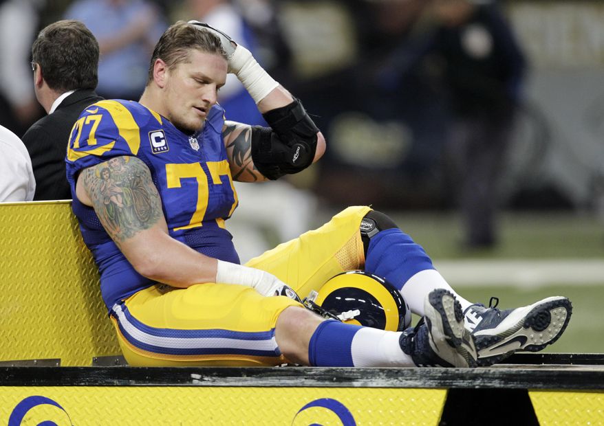 FILE - In this Dec. 22, 2013, file photo, St. Louis Rams offensive tackle Jake Long is taken off the field on a cart after being injured during an NFL football game against the Tampa Bay Buccaneers in St. Louis. Long is eager to revive his career with the Atlanta Falcons. The No. 1 overall draft pick by Miami in 2008, Long has been plagued by injuries in recent years and didn't even hook on with a team during training camp. But the Falcons, looking to improve depth on their offensive line, signed the tackle to a one-year deal. Long went through his first practice with his new team Wednesday, Sept. 16, 2015. He is listed as third string on the depth chart and isn't expected to play this weekend against the New York Giants. (AP Photo/Tom Gannam, File)