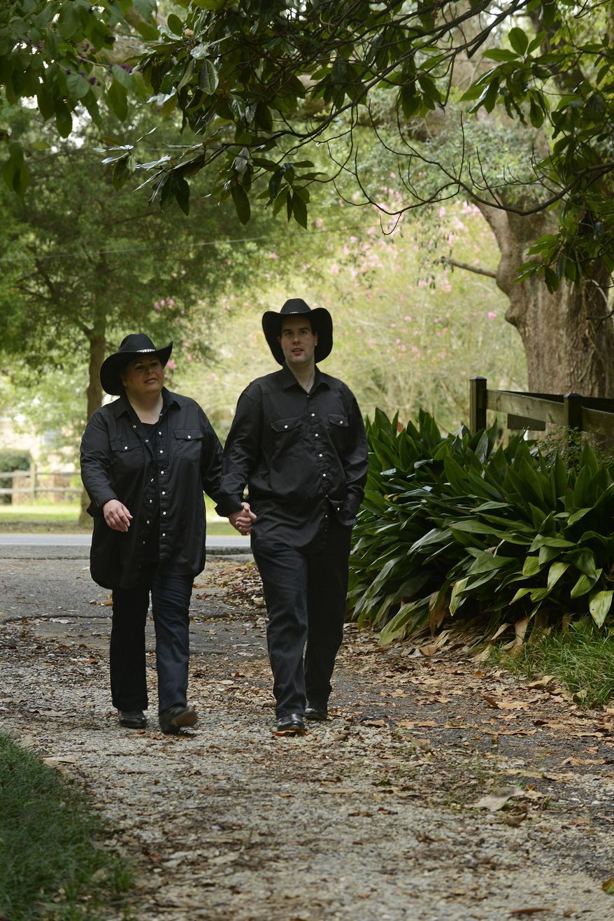 ADVANCE FOR THE WEEKEND OF SEPT. 19-10 AND THEREAFTER - In an Aug. 30, 2015 photo, Anita Lesko and her fiance' Abraham Nielson walk near at their home, in Pebsacola. Both are autistic and are fundraising for their wedding. Their wedding will take place at the annual Love & Autism Conference in San Diego on September 26. (John Blackie/Pensacola News Journal via AP) NO SALES; MANDATORY CREDIT