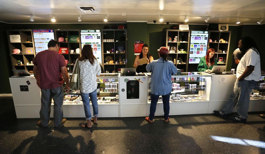 Customers shop for Marijuana inside The Grass Station recreational marijuana store, in Denver, Colo., Wednesday, Sept. 16, 2015. (AP Photo/Brennan Linsley)
