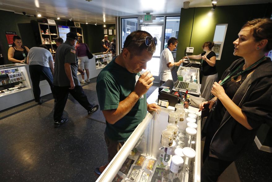 Customers shop inside The Grass Station recreational marijuana store in Denver, Colo., Wednesday, Sept. 16, 2015. (AP Photo/Brennan Linsley) ** FILE **