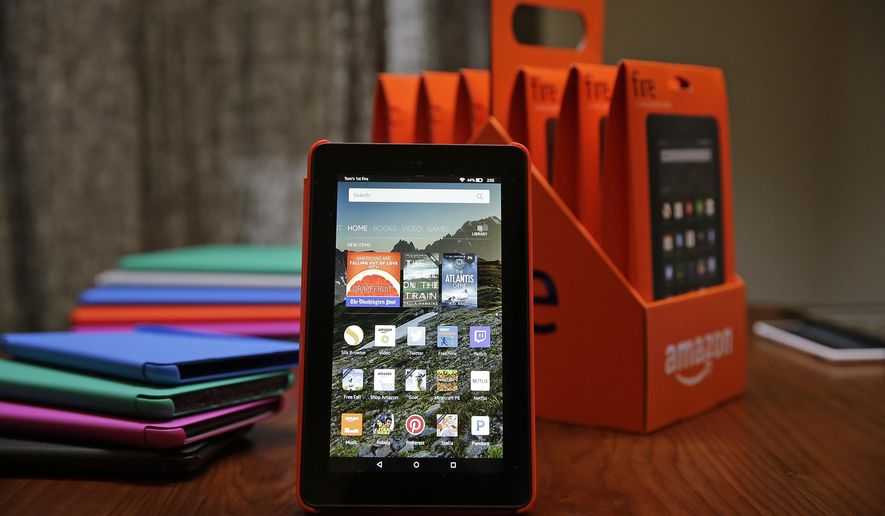 In this Wednesday, Sept. 16, 2015, photo, Amazon's new $50 Fire tablet is displayed next to a six-pack of them and assorted colored cases in San Francisco. Amazon.com is introducing the $50 tablet computer in its latest attempt to boost its online store sales by luring consumers who can’t afford more expensive Internet-connected devices made by Apple and other rivals. (AP Photo/Eric Risberg)