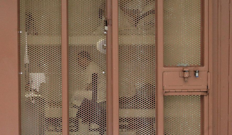 FILE -- In this Aug. 17, 2011, file photo, a pair of inmates are seen in their cell in the Security Housing Unit at the Pelican Bay State Prison near Crescent City, Calif. Inmates say newly imposed welfare checks in the SHU have created excessive noise by the guards, causing California prison officials to hand out earplugs to inmates and tell the guards to walk softly while going about their rounds. (AP Photo/Rich Pedroncelli, file)