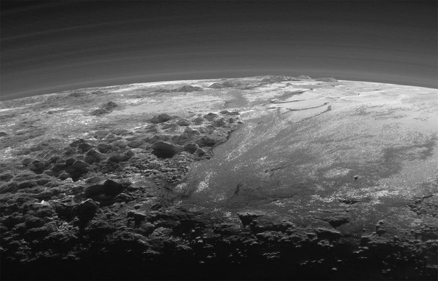 This July 14, 2015 photo released by NASA on Thursday, Sept. 17, 2015 shows the atmosphere and surface features of Pluto, lit from behind by the sun. It was made 15 minutes after the New Horizons' spacecraft's closest approach. (NASA/JHUAPL/SwRI via AP)