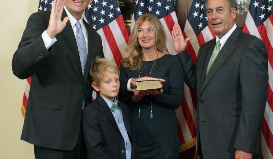 House Speaker John Boehner of Ohio administers the oath of office to Rep.-elect Darin LaHood, R-Ill., during a ceremonial swearing-in ceremony on Capitol Hill in Washington, Thursday, Sept. 17, 2015. LaHood is accompanied by his wife Kristen, and son Teddy, 8. Afterward LaHood was to be officially sworn into the House on the House floor. (AP Photo/Lauren Victoria Burke)