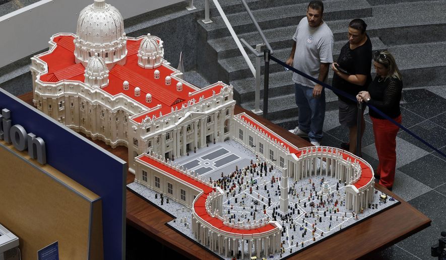 In this Friday, Sept. 11, 2015 photo, visitors view a Lego representation of the St. Peter’s basilica and square, at The Franklin Institute in Philadelphia. The Rev. Bob Simon spent about 10 months building it with approximately half-a-million Legos. (AP Photo/Matt Rourke)