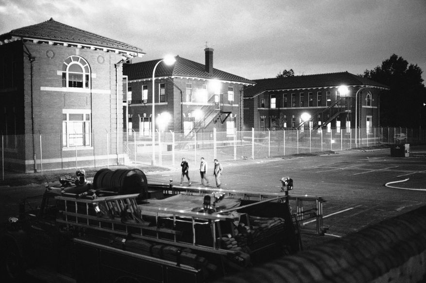 U.S. Park Police enter St. Elizabeth?s Hospital in Washington on Monday, Oct. 20, 1980 ending a six hour takeover by Cuban refugees who were transferred to the hospital for psychiatric observation. (AP Photo/Barry Thumma)