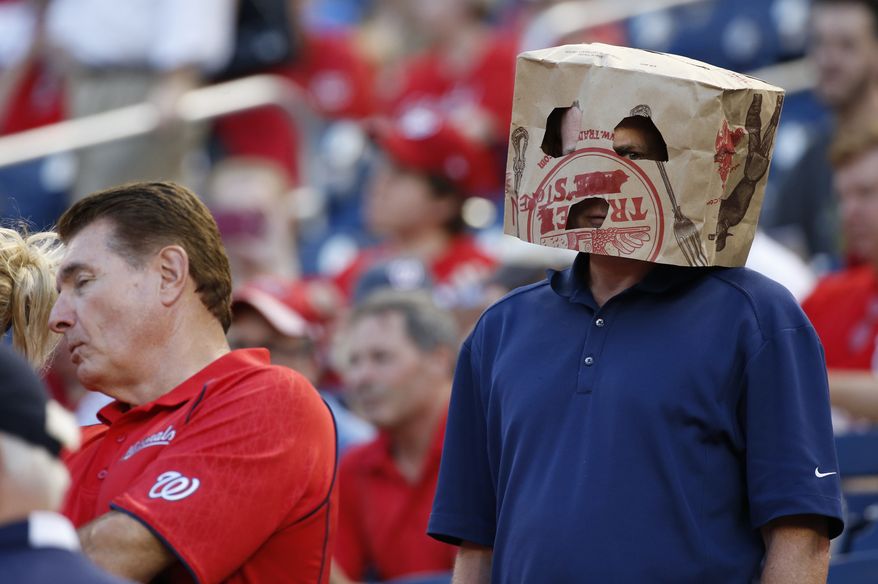 A fan wears a bag over his head before a baseball game between the Washington Nationals and the New York Mets at Nationals Park, Wednesday, Sept. 9, 2015, in Washington. (AP Photo/Alex Brandon)