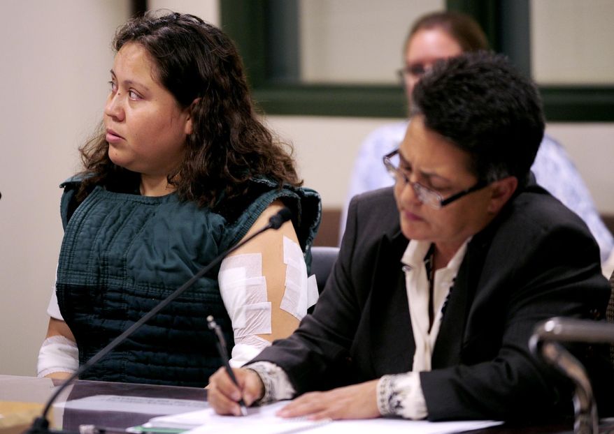 Lucia Hernandez Alvarez, left, sits in court Thursday, Sept. 17, 2015 in Kenosha, Wis. Alvarez was charged with first-degree intentional homicide Thursday in the deaths of her two young children, 3-year-old daughter, Alicia, and 1-year-old son, Javier, whom prosecutors say she drugged and suffocated Saturday, Sept. 12 before stabbing herself in a failed suicide attempt. She is represented by public defender Larissa Beniez- Morgan. (Kevin Poirier/Kenosha News via AP)